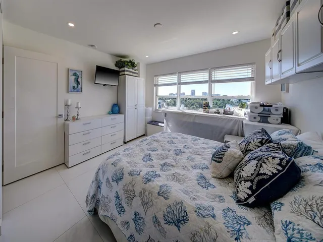 a bed room with a bed and a large window