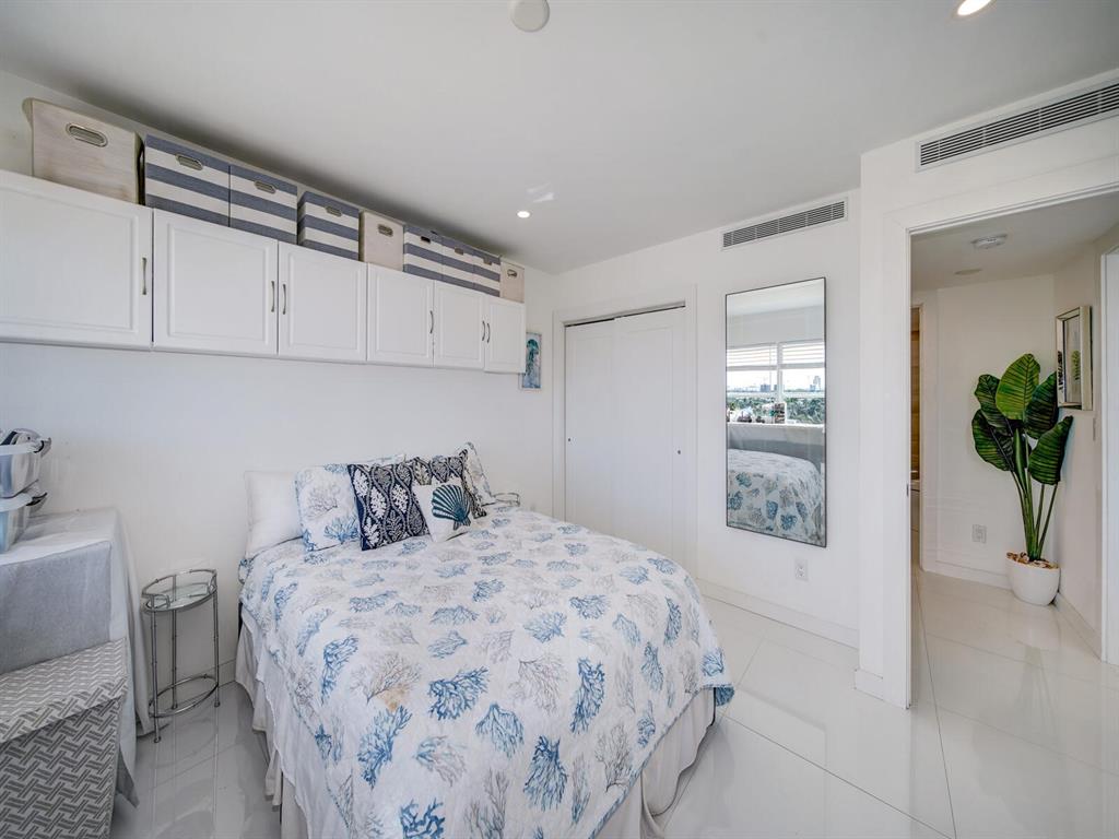 2500 East Las Olas Boulevard, Unit 707 Fort Lauderdale, FL 33301 - Photo 15 of 29 a bedroom with a large bed and a potted plant