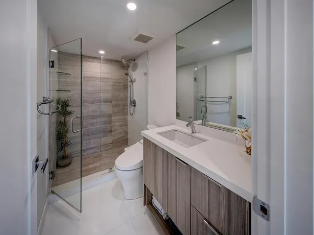 a bathroom with a sink toilet and shower