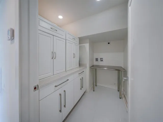 a bathroom with white cabinets