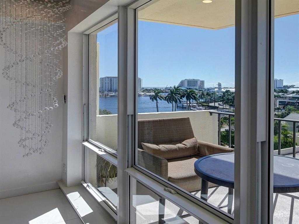 2500 East Las Olas Boulevard, Unit 707 Fort Lauderdale, FL 33301 - Photo 18 of 29 a view of a balcony with chair and wooden floor