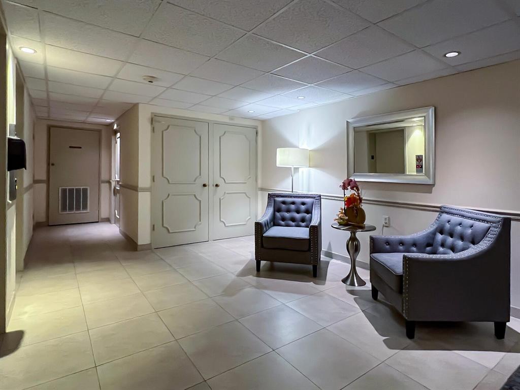 2500 East Las Olas Boulevard, Unit 707 Fort Lauderdale, FL 33301 - Photo 24 of 29 a living room with furniture and a fireplace