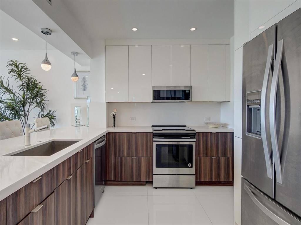 2500 East Las Olas Boulevard, Unit 707 Fort Lauderdale, FL 33301 - Photo 3 of 29 a kitchen with stainless steel appliances granite countertop a refrigerator sink and stove