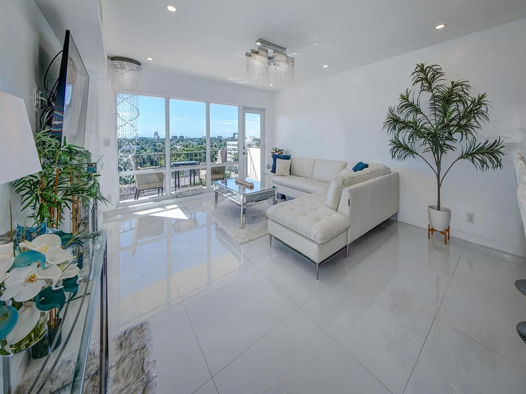 2500 East Las Olas Boulevard, Unit 707 Fort Lauderdale, FL 33301 - Photo 6 of 29 a living room with furniture potted plant and a large window