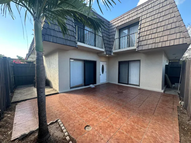a view of backyard with a large tree
