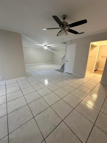 a view of a livingroom with a ceiling fan and window