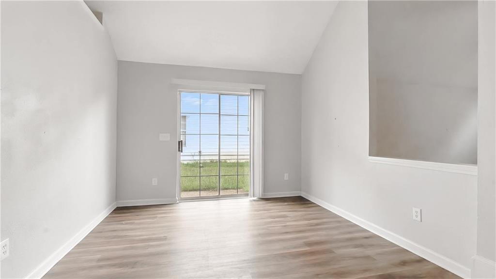 4890 Wilkins Station Drive Decatur, GA 30035 - Photo 13 of 34 an empty room with wooden floor and windows