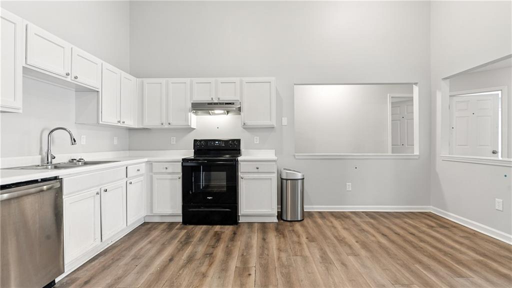 4890 Wilkins Station Drive Decatur, GA 30035 - Photo 16 of 34 a kitchen with granite countertop a sink and a stove top oven