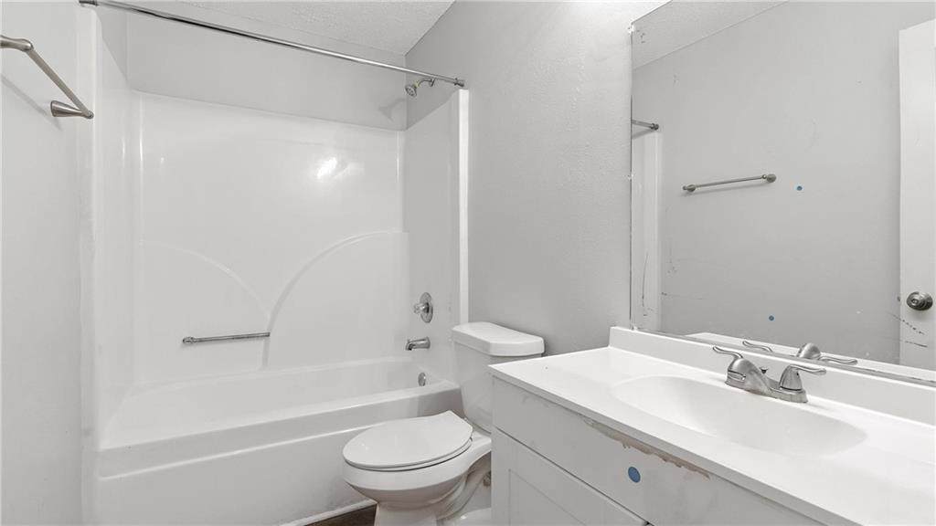 4890 Wilkins Station Drive Decatur, GA 30035 - Photo 18 of 34 a bathroom with a sink toilet vanity and shower