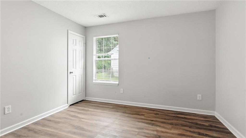 4890 Wilkins Station Drive Decatur, GA 30035 - Photo 19 of 34 an empty room with wooden floor and windows