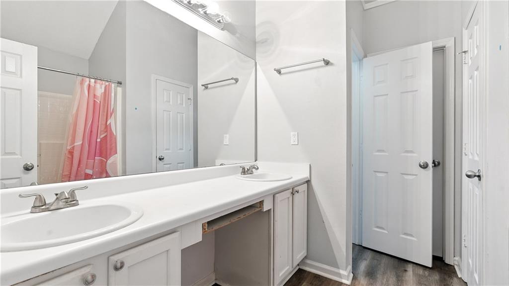 4890 Wilkins Station Drive Decatur, GA 30035 - Photo 25 of 34 a bathroom with a sink and a mirror