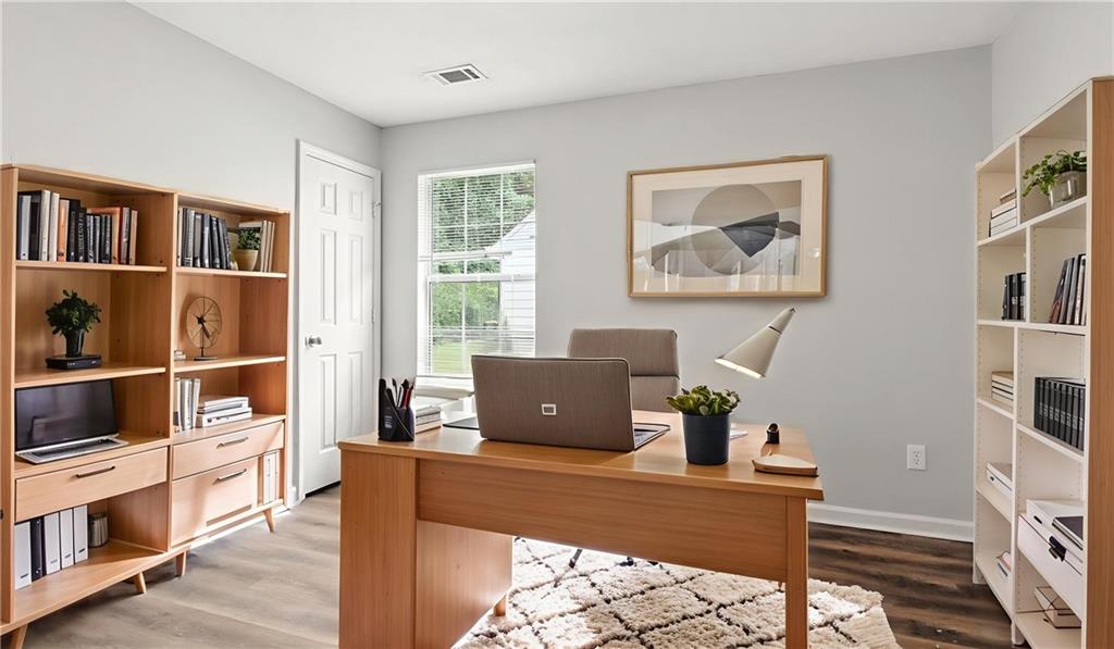 4890 Wilkins Station Drive Decatur, GA 30035 - Photo 7 of 34 a living room with furniture a flat screen tv and a window