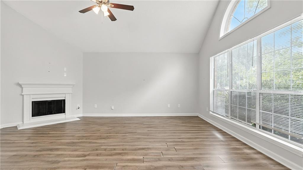 4890 Wilkins Station Drive Decatur, GA 30035 - Photo 10 of 34 a view of an empty room with wooden floor and a window