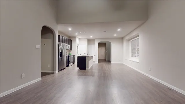 a view of kitchen with refrigerator and window