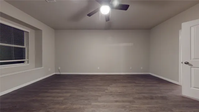 a view of a room with wooden floor and window