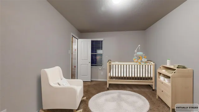 a bed room with a bed and a large window