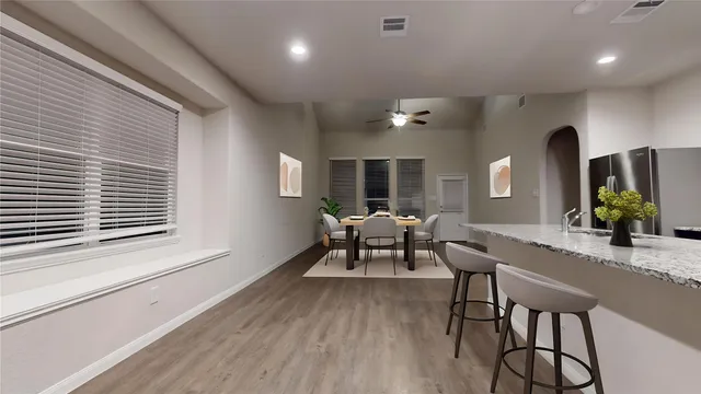 a view of a kitchen with stainless steel appliances granite countertop a stove a refrigerator and a refrigerator