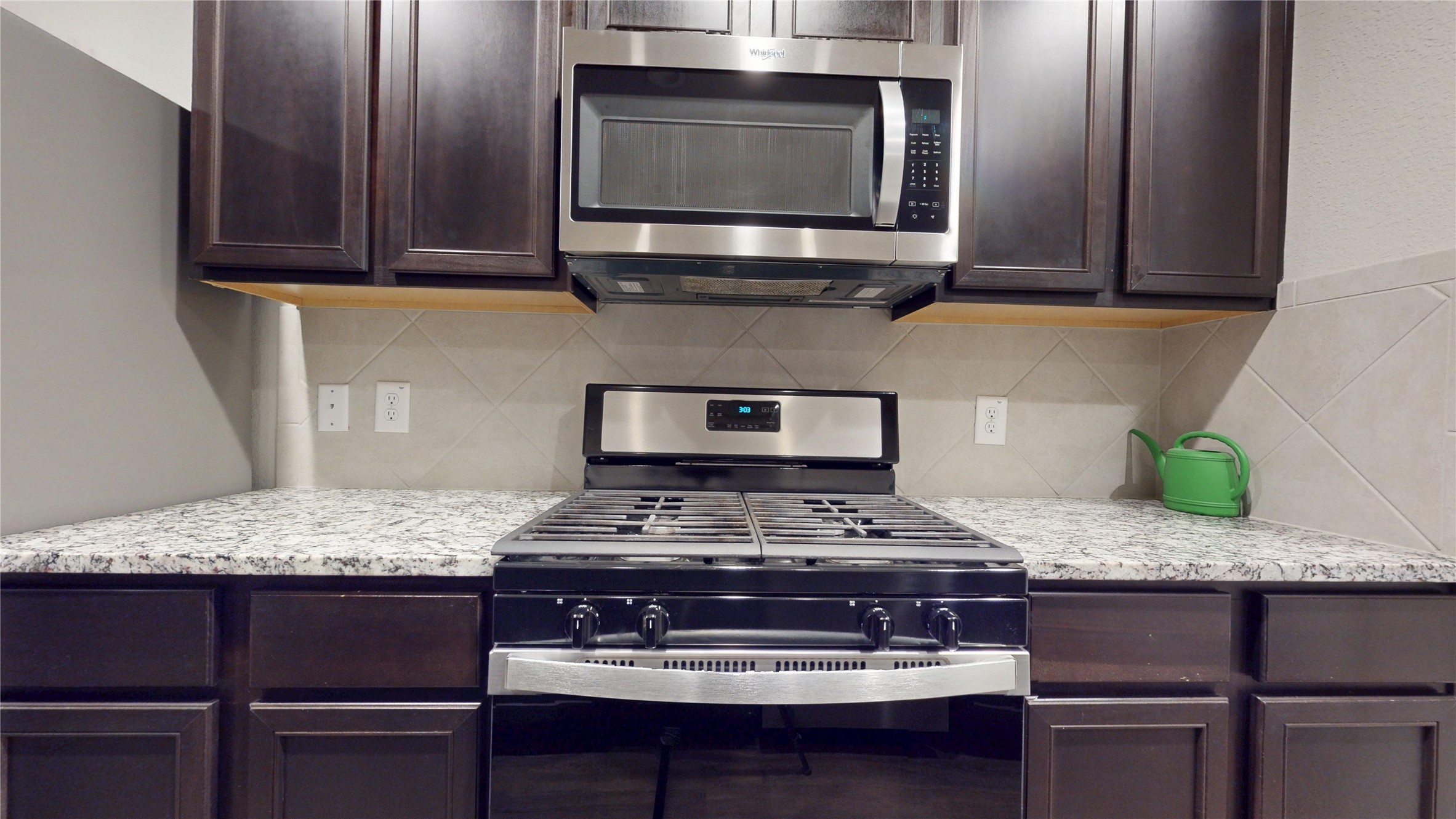 3535 Cannon Drive Conroe, TX 77301 - Photo 8 of 49 a kitchen with stainless steel appliances granite countertop a stove and a microwave