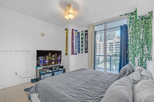 a bedroom with a bed furniture and a flat screen tv