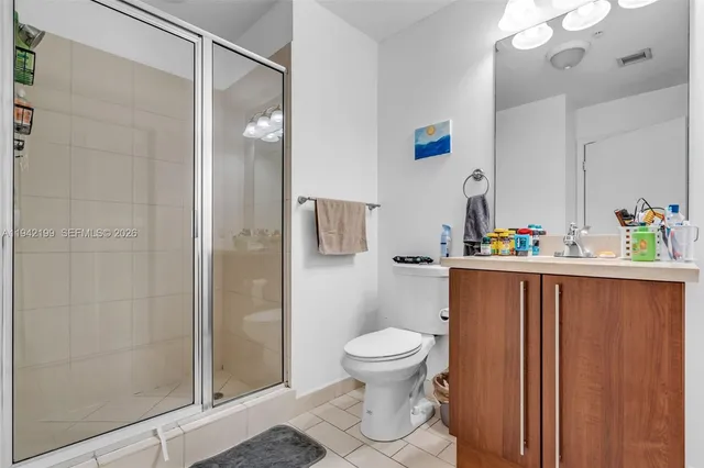 a bathroom with a toilet and a shower