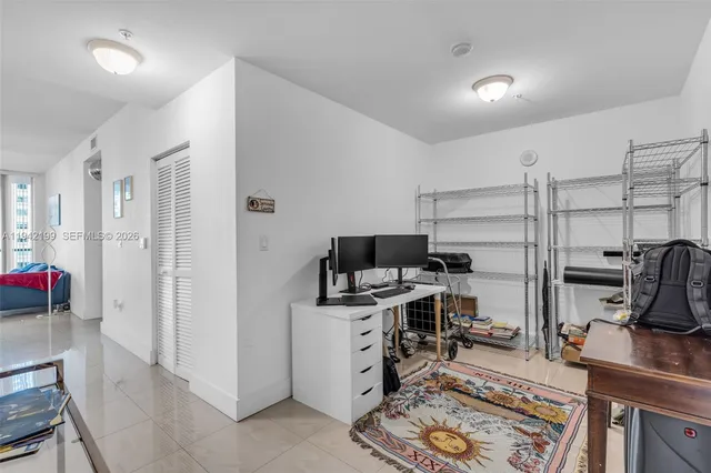a view of a workspace with furniture and a flat screen tv