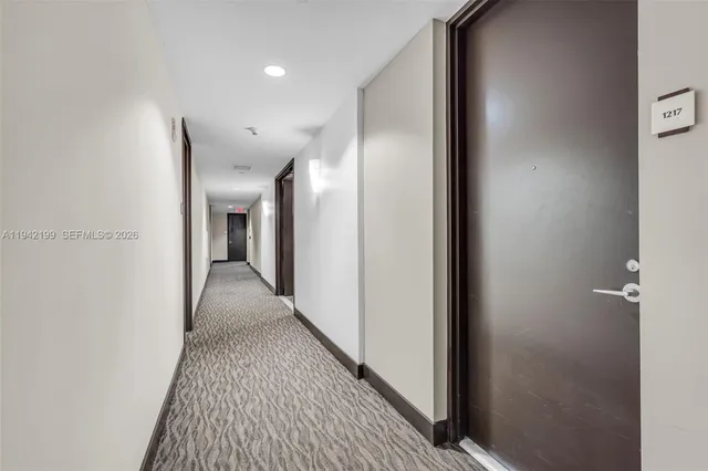 a view of hallway with wooden floor
