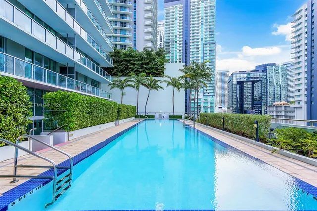 a living room with furniture and floor to ceiling window