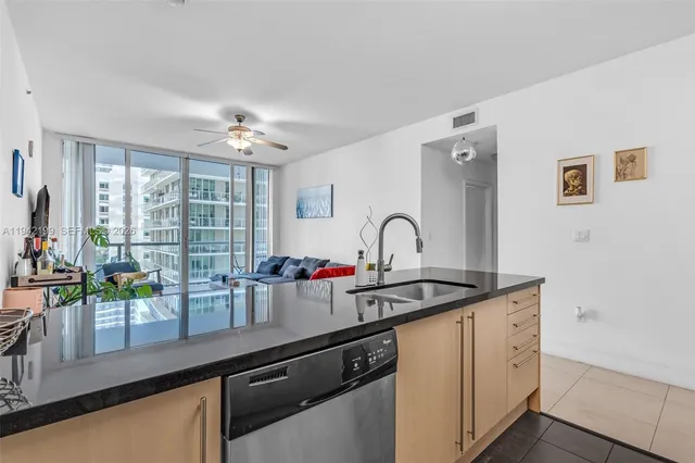 a kitchen with stainless steel appliances a sink and cabinets