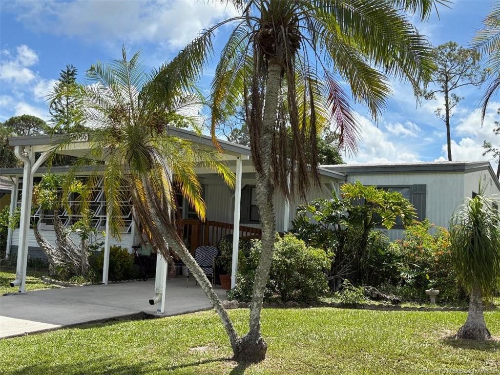 2686 Southwest Monarch Trail Stuart, FL 34997 - Photo 2 of 15 a view of a house with a yard