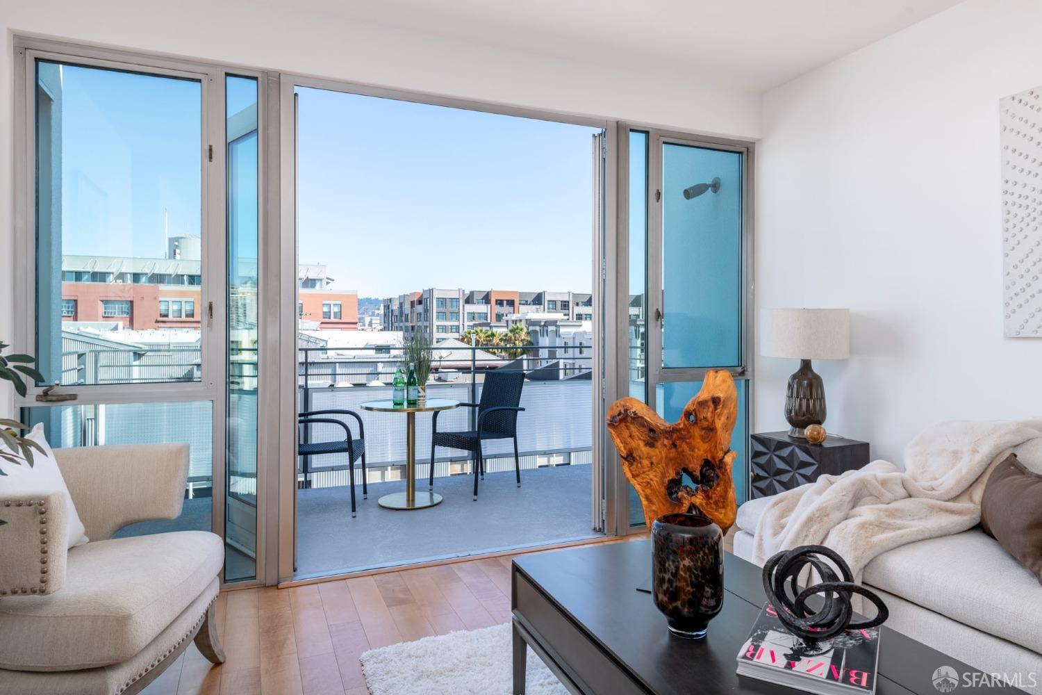 200 2nd Street, Unit 503 Oakland, CA 94607 - Photo 2 of 24 a living room with furniture and a floor to ceiling window