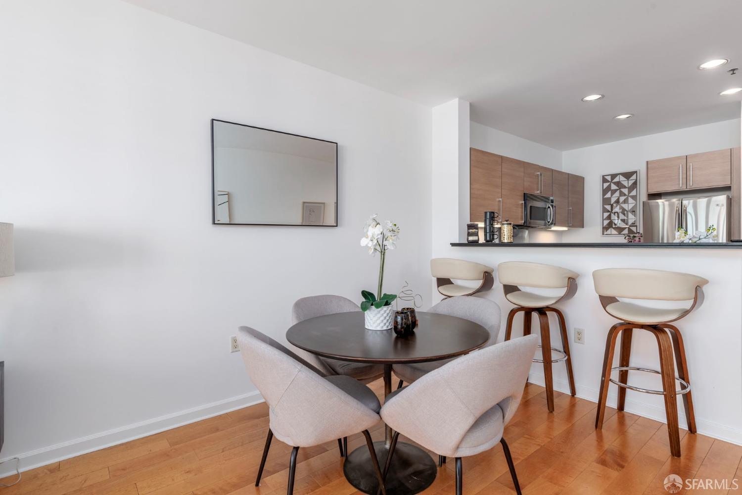 200 2nd Street, Unit 503 Oakland, CA 94607 - Photo 7 of 24 a view of a dining room with furniture and wooden floor
