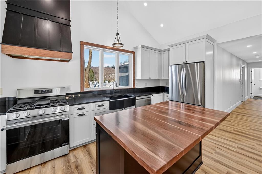 392 Stuber Road Beaver Falls, PA 15010 - Photo 11 of 48 a kitchen with stainless steel appliances granite countertop a stove a sink and a refrigerator