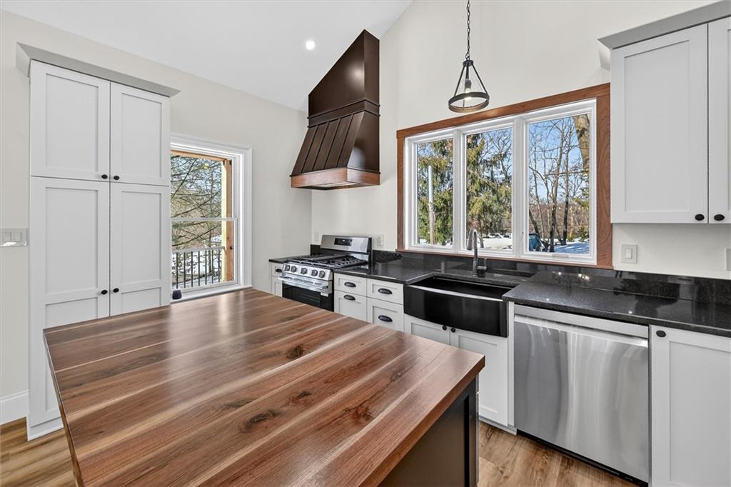 392 Stuber Road Beaver Falls, PA 15010 - Photo 12 of 48 a kitchen with stainless steel appliances granite countertop a stove a sink and a microwave