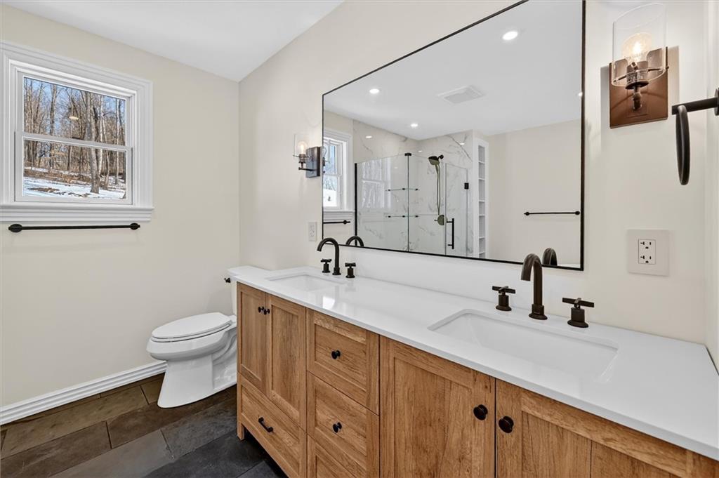 392 Stuber Road Beaver Falls, PA 15010 - Photo 26 of 48 a bathroom with a double vanity sink toilet and a mirror