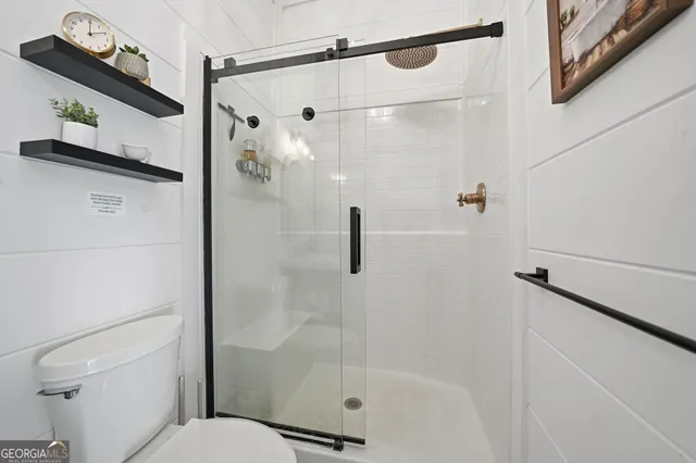 a bathroom with a shower and toilet