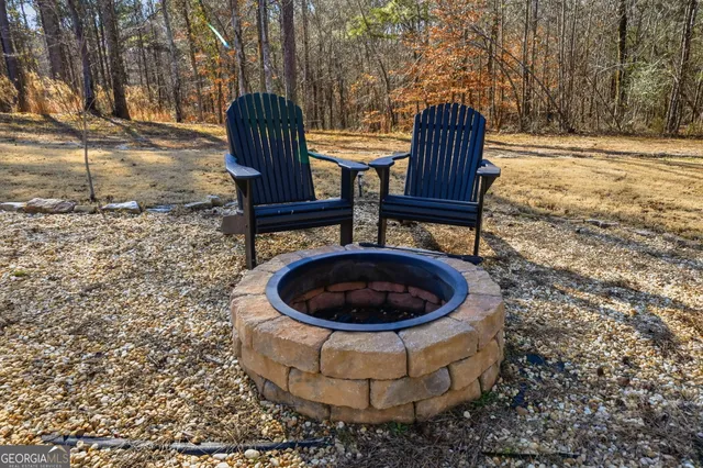 a view of barbeque grill with wooden fence