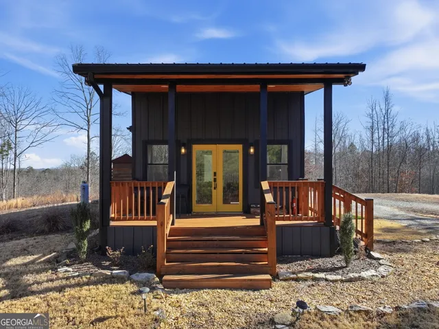 a backyard of a house with table and chairs