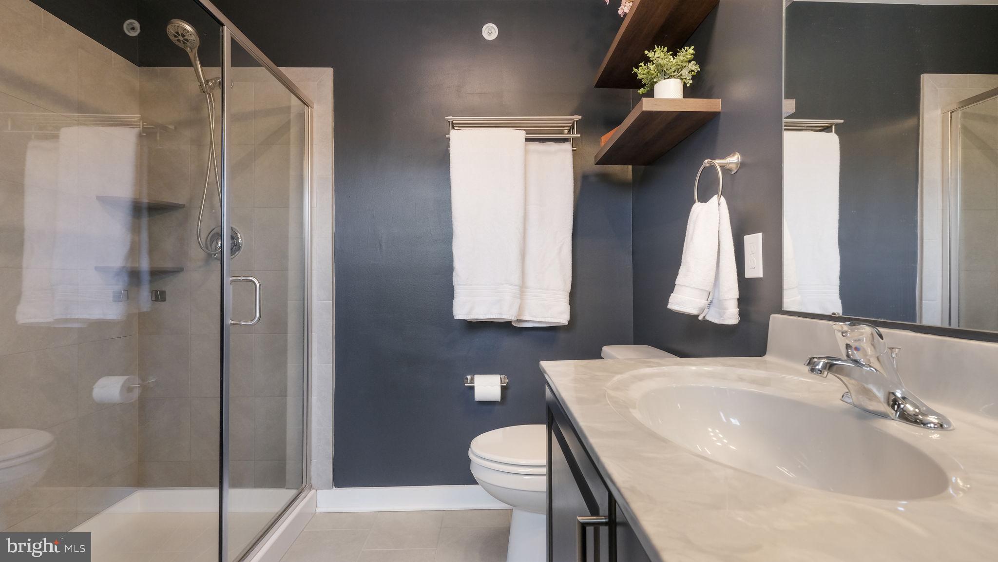 42 Independence Court Perkasie, PA 18944 - Photo 18 of 23 a bathroom with a sink and mirror with toilet