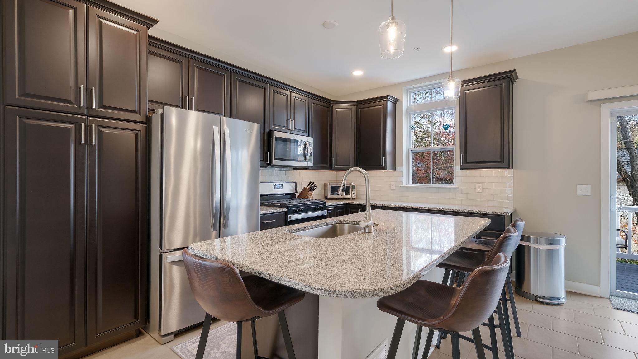42 Independence Court Perkasie, PA 18944 - Photo 9 of 23 a kitchen with granite countertop a refrigerator and microwave