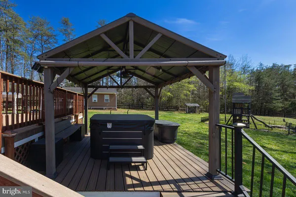 a view of a porch with wooden floor and outdoor space