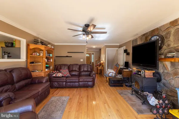 a bedroom with a bed potted plant on dresser and a chandelier