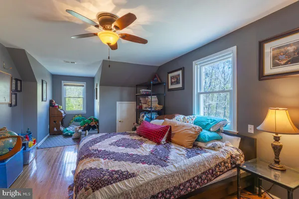 a bedroom with a bed couch and a chandelier