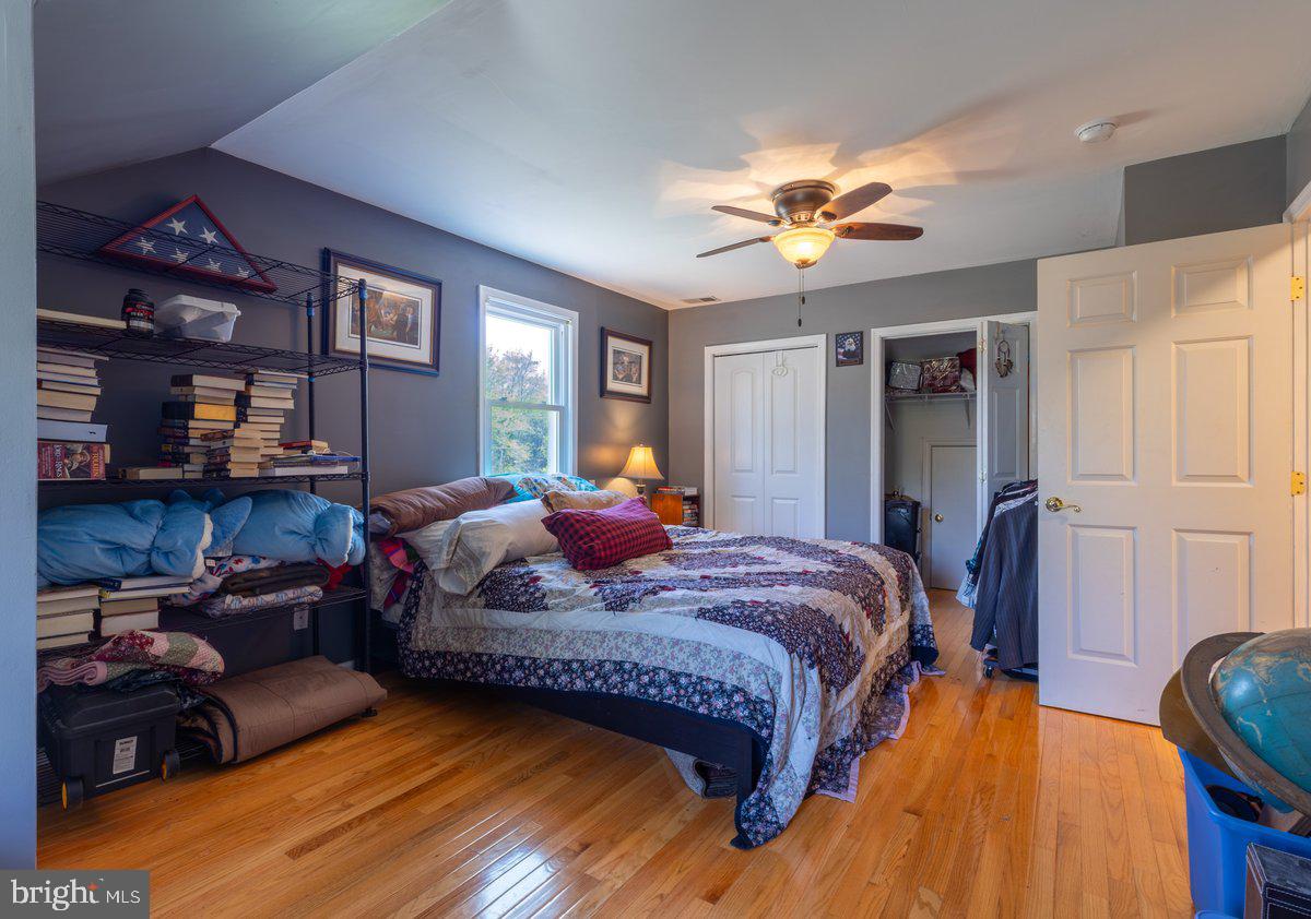 2113 Courthouse Road Catlett, VA 20119 - Photo 26 of 36 a bedroom with a bed couch and a chandelier