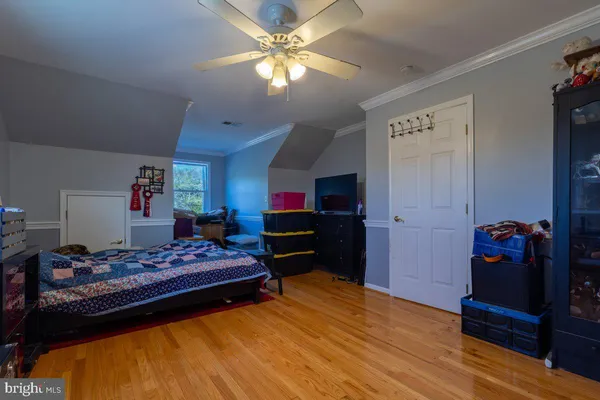 a bedroom with furniture and a wooden floor