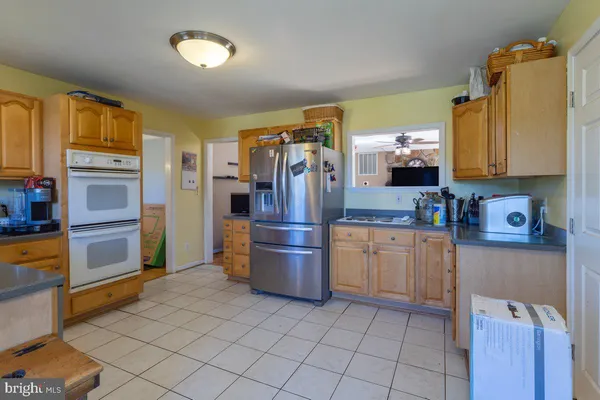a kitchen with stainless steel appliances granite countertop a refrigerator and a stove