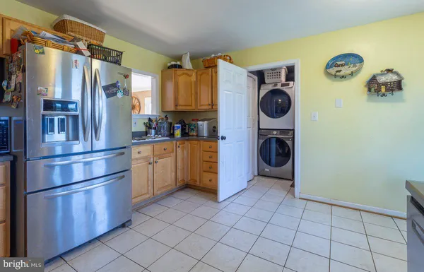 a kitchen with granite countertop a refrigerator and a sink