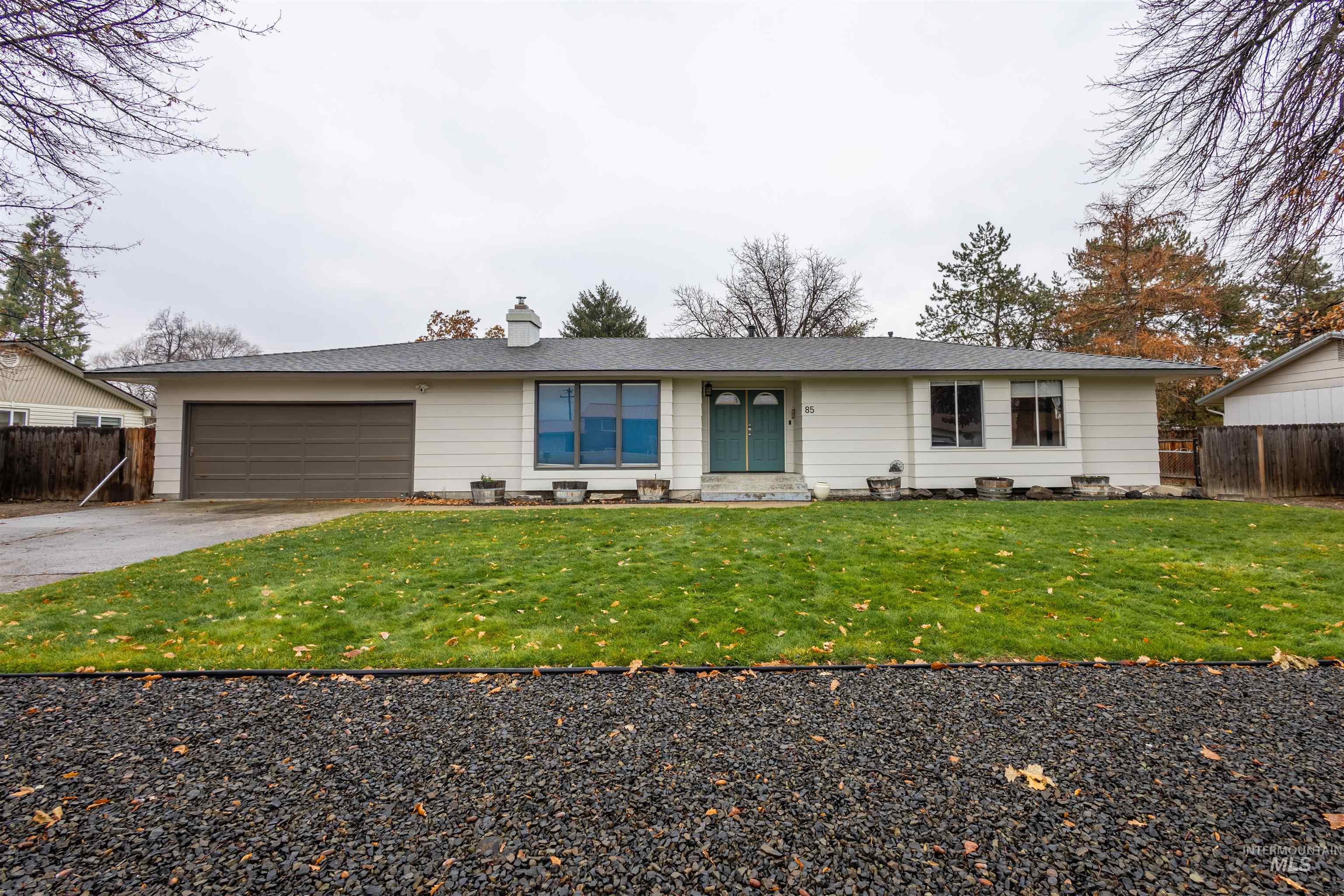 85 Northwest 16th Street Ontario, OR 97914 - Photo 1 of 25 Single story home featuring a chimney, driveway, and an attached garage