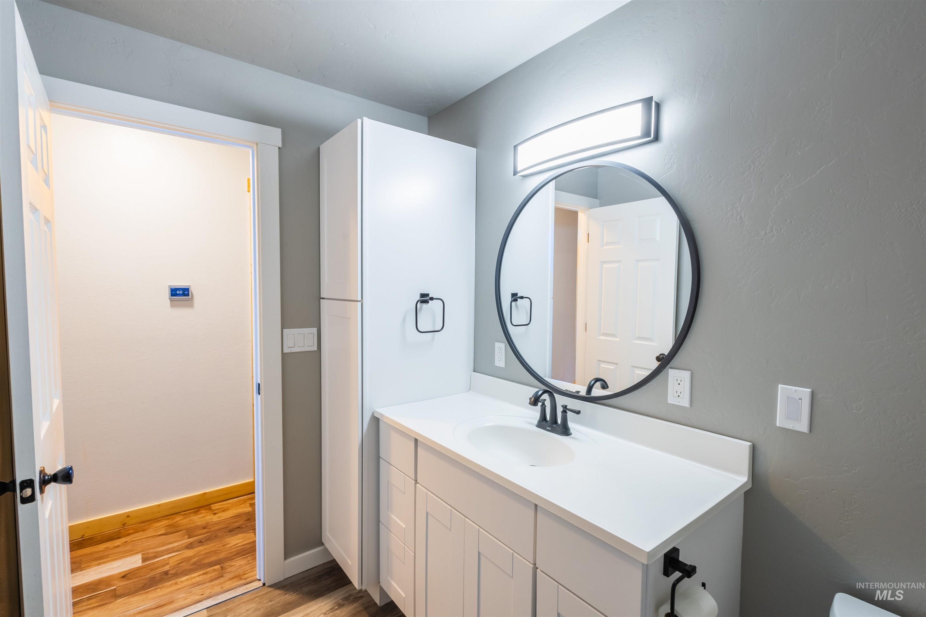 85 Northwest 16th Street Ontario, OR 97914 - Photo 19 of 25 Half bath featuring light wood-style flooring and vanity