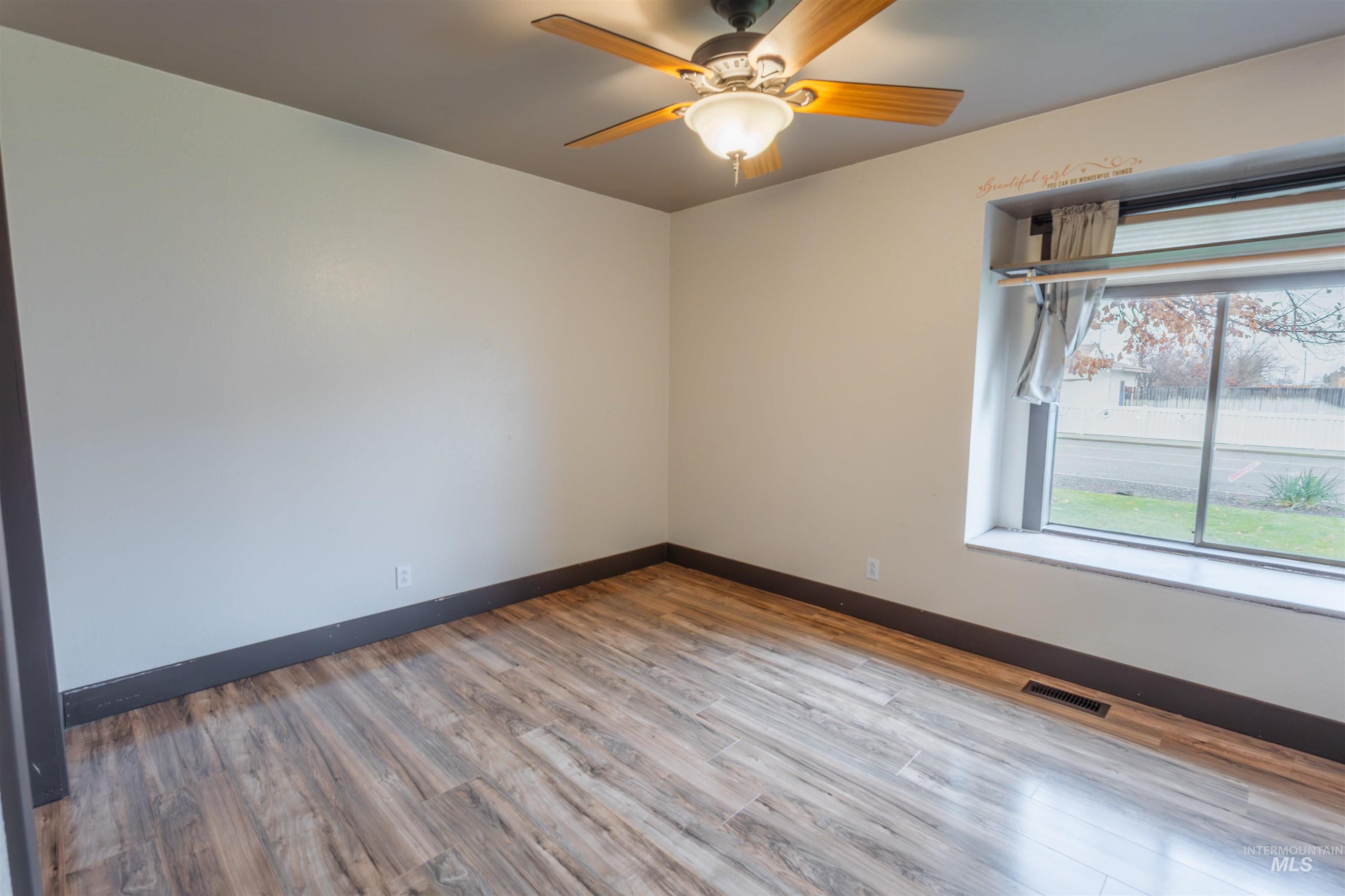 85 Northwest 16th Street Ontario, OR 97914 - Photo 23 of 25 Empty room with light wood-type flooring and ceiling fan