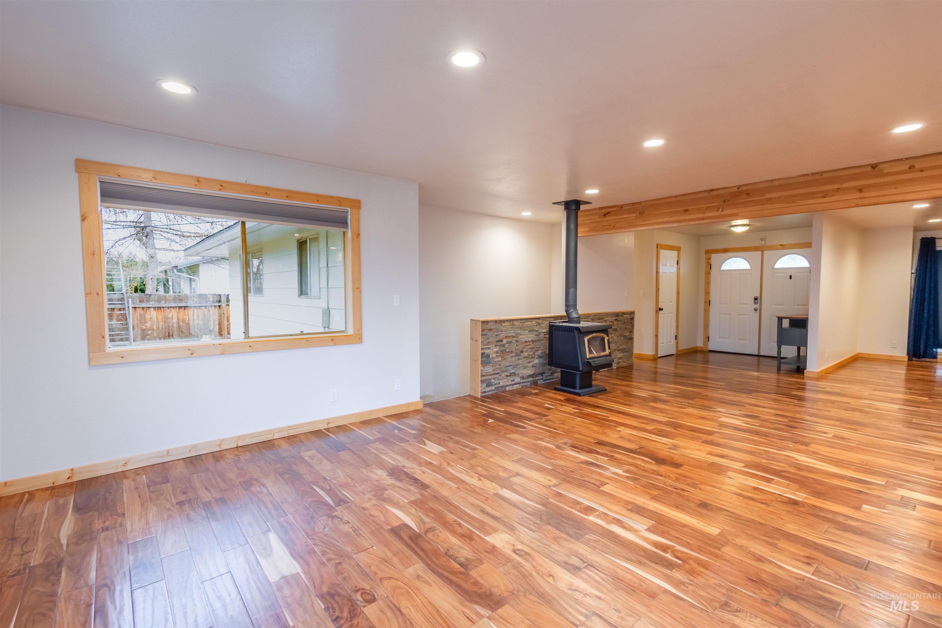 85 Northwest 16th Street Ontario, OR 97914 - Photo 9 of 25 Unfurnished living room with a wood stove, light wood-style floors, and recessed lighting